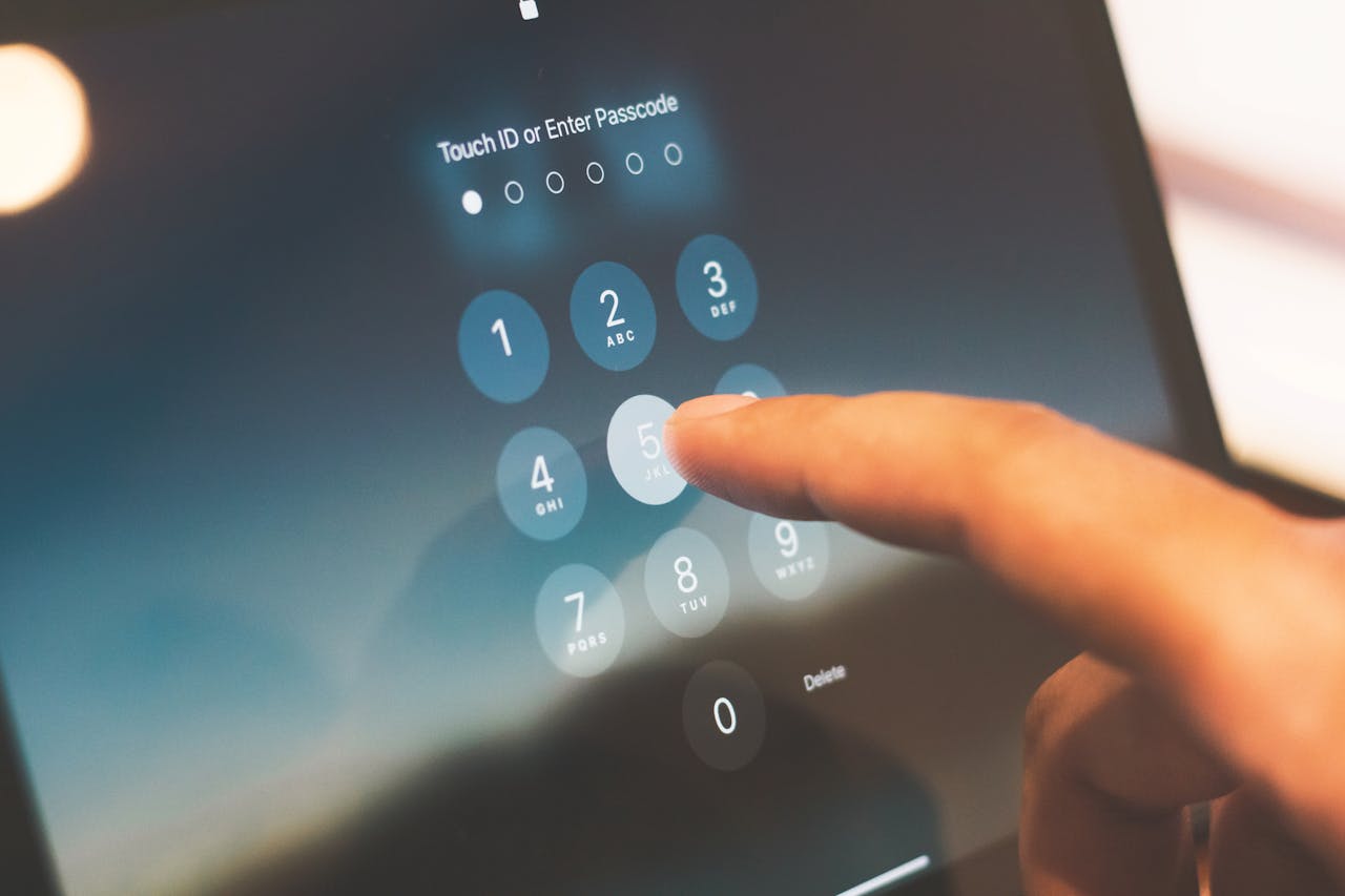Finger entering a passcode on a device screen showing an extra verification step for Dropbox two-factor authentication