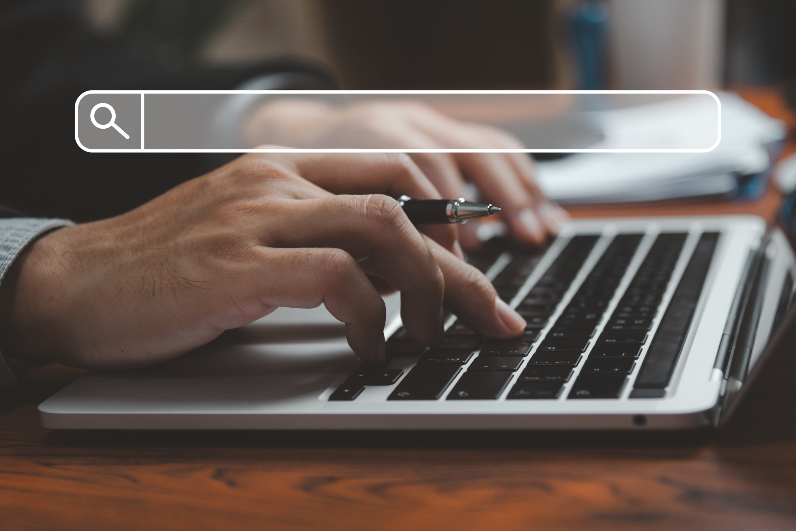 Person typing on a laptop with a search bar overlay, representing website search visibility and lead generation performance