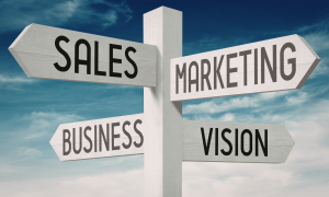 Signpost pointing to sales, marketing, business, and vision, representing a clear go to market strategy for small business growth.