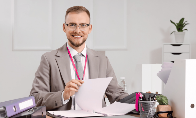 Business consultant reviewing documents and folders while preparing a small business marketing plan.