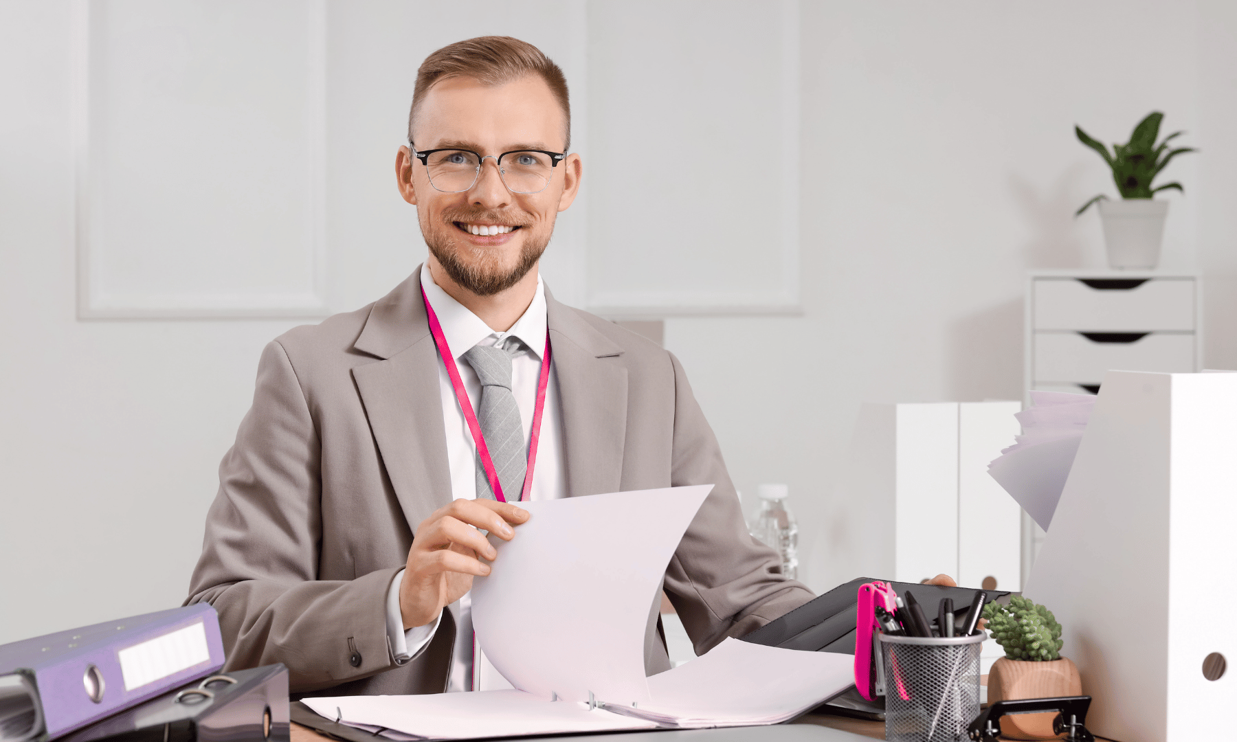 Business consultant reviewing documents and folders while preparing a small business marketing plan.