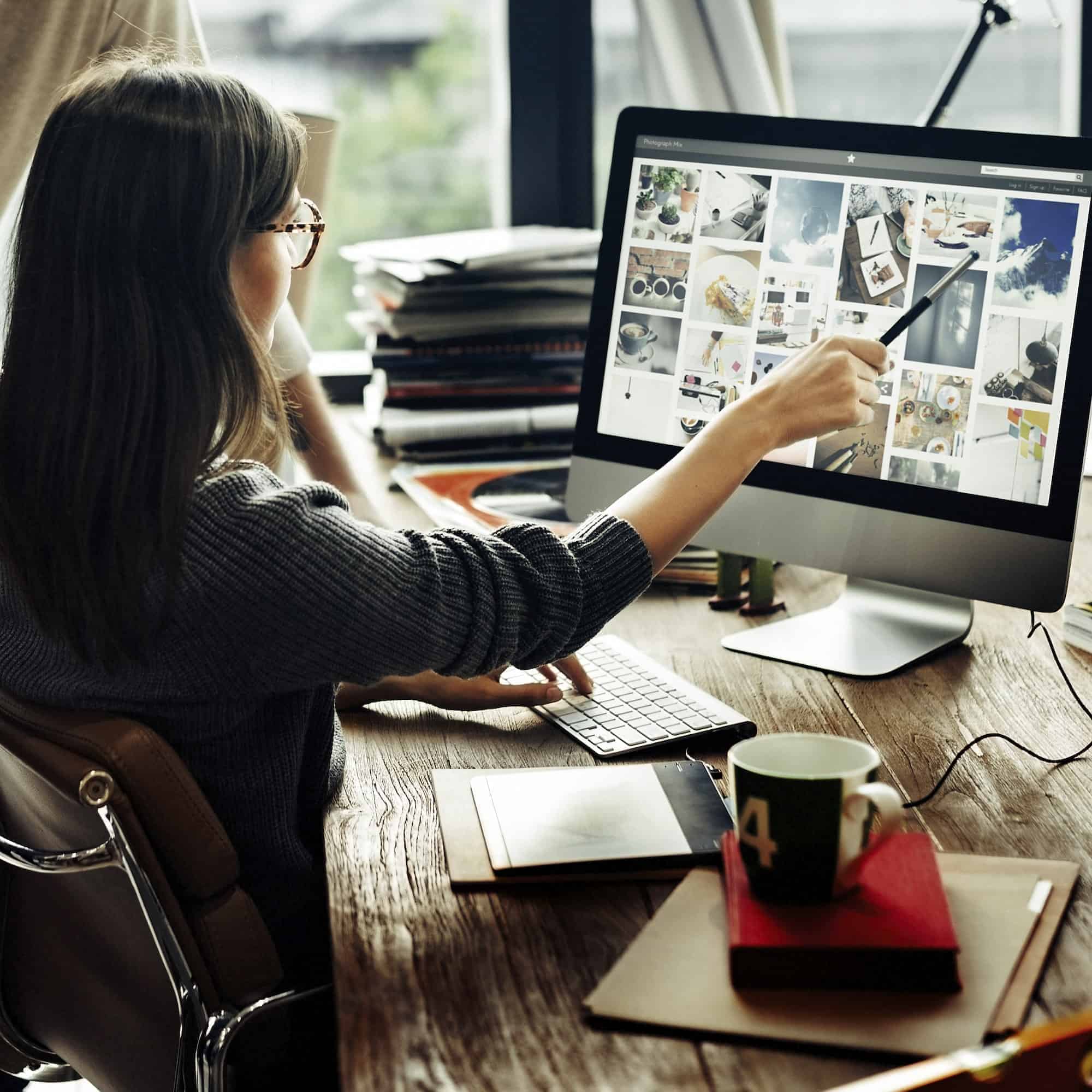 Business professional using digital tools to review website content and support technology-driven business growth.